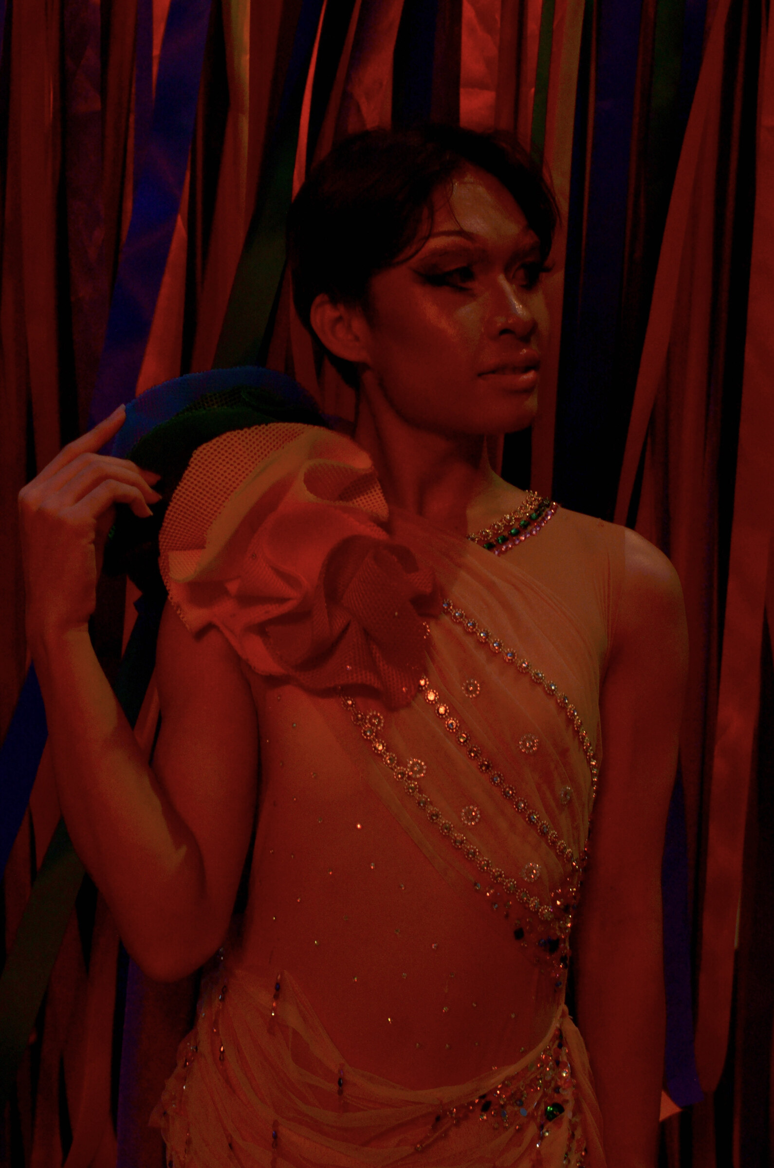 Performer in red against the streamers