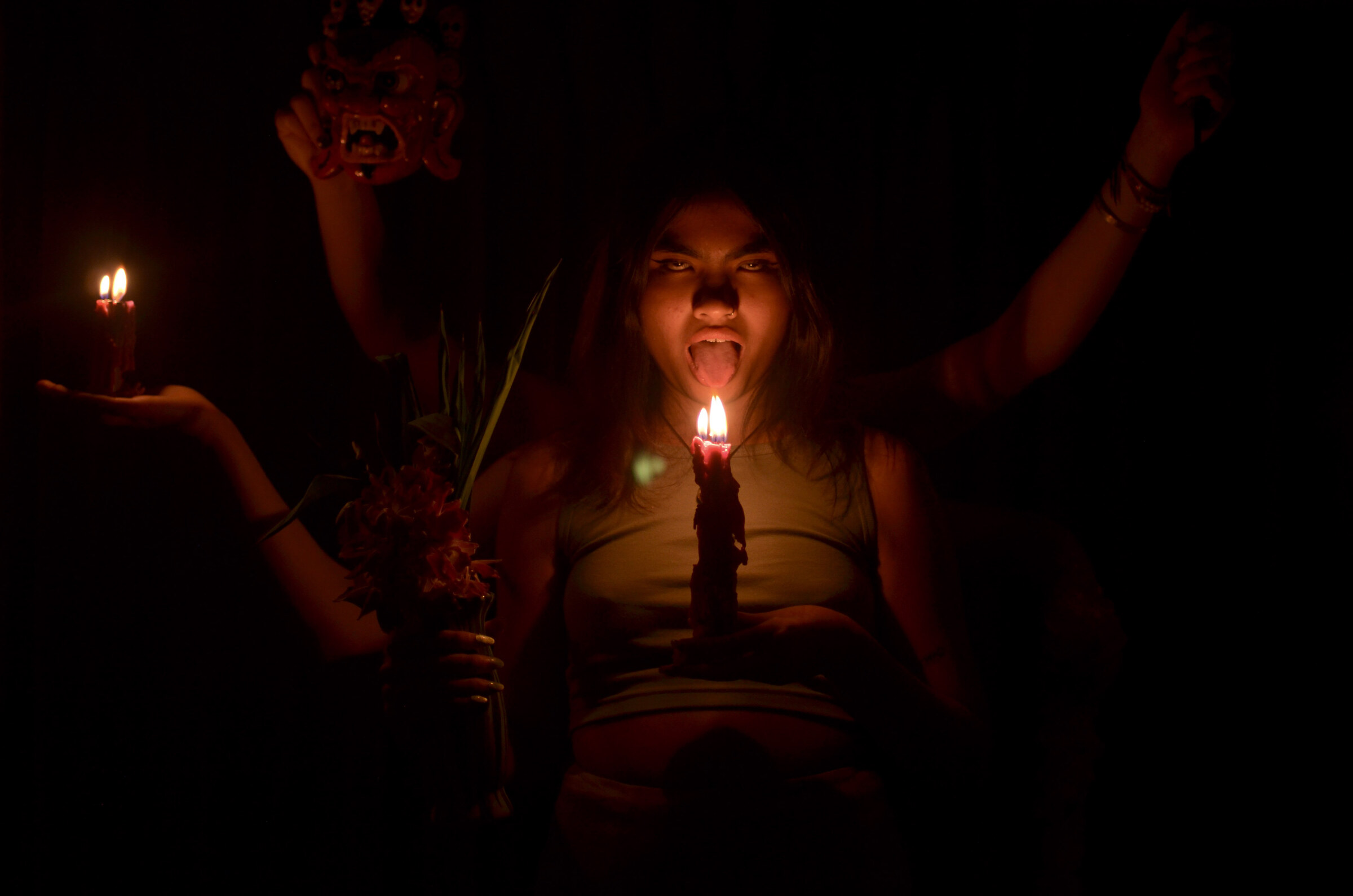 Candle held to the tongue, mask above