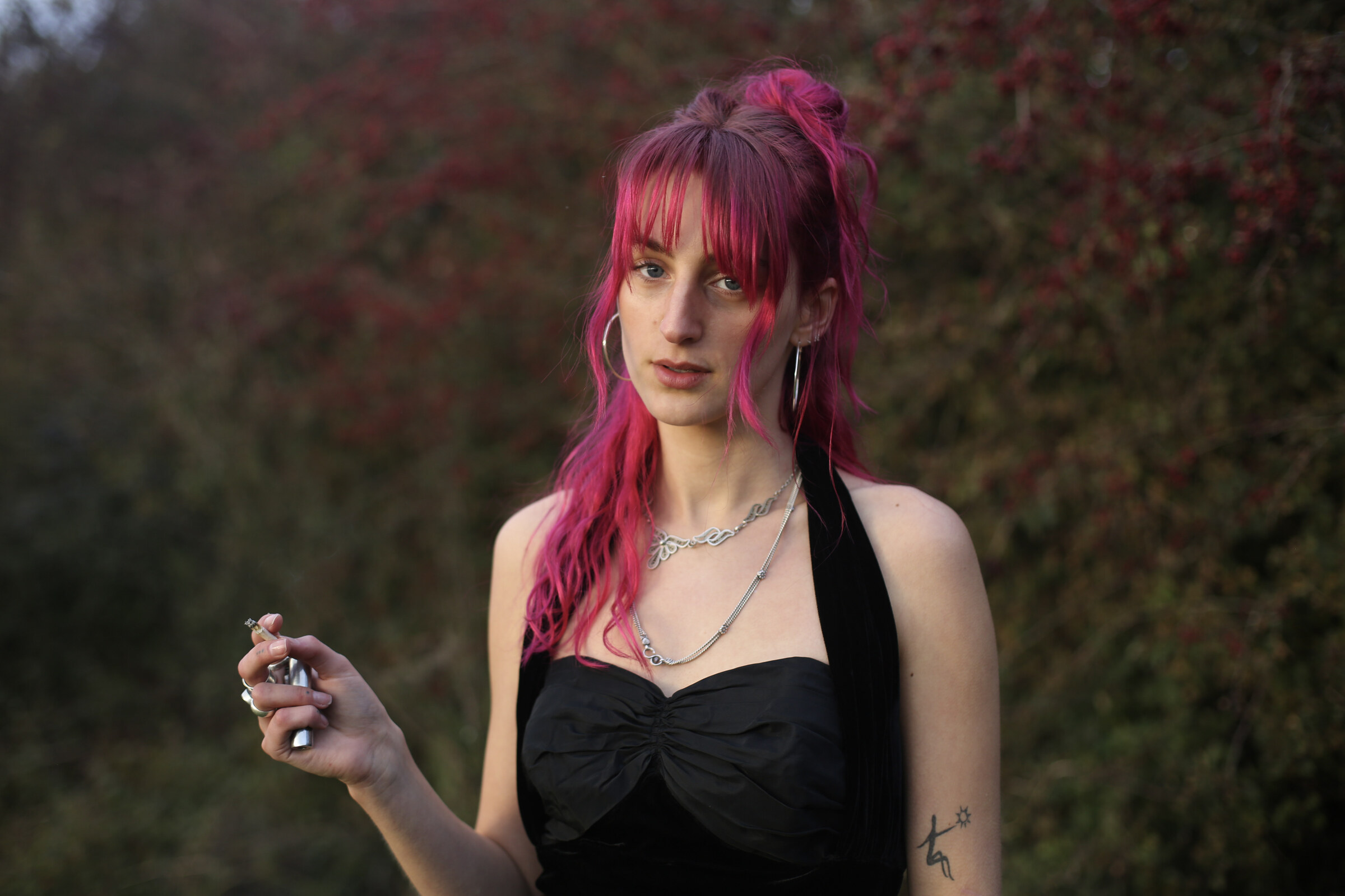 Pink-haired portrait against the berry hedge