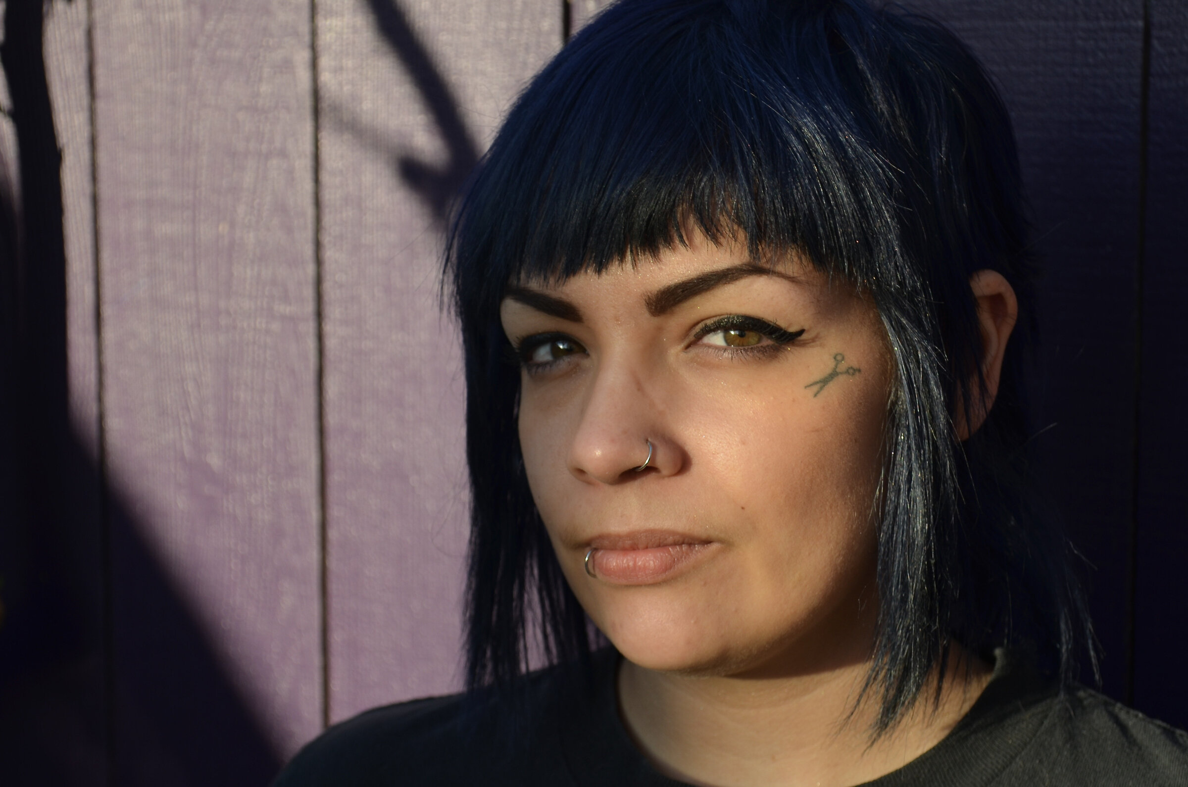 Tattooed woman in hard window light