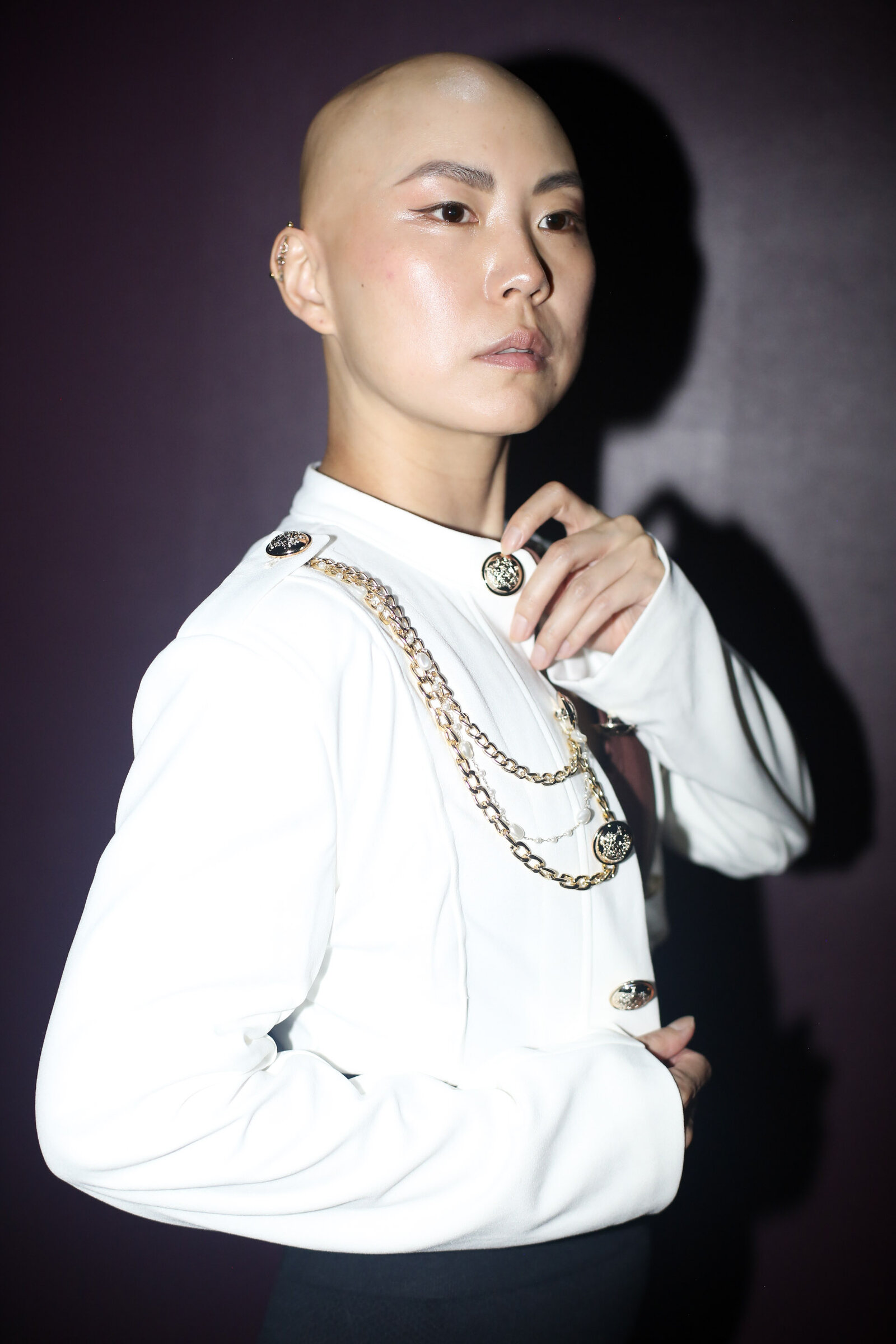 Studio portrait in white shirt and chains