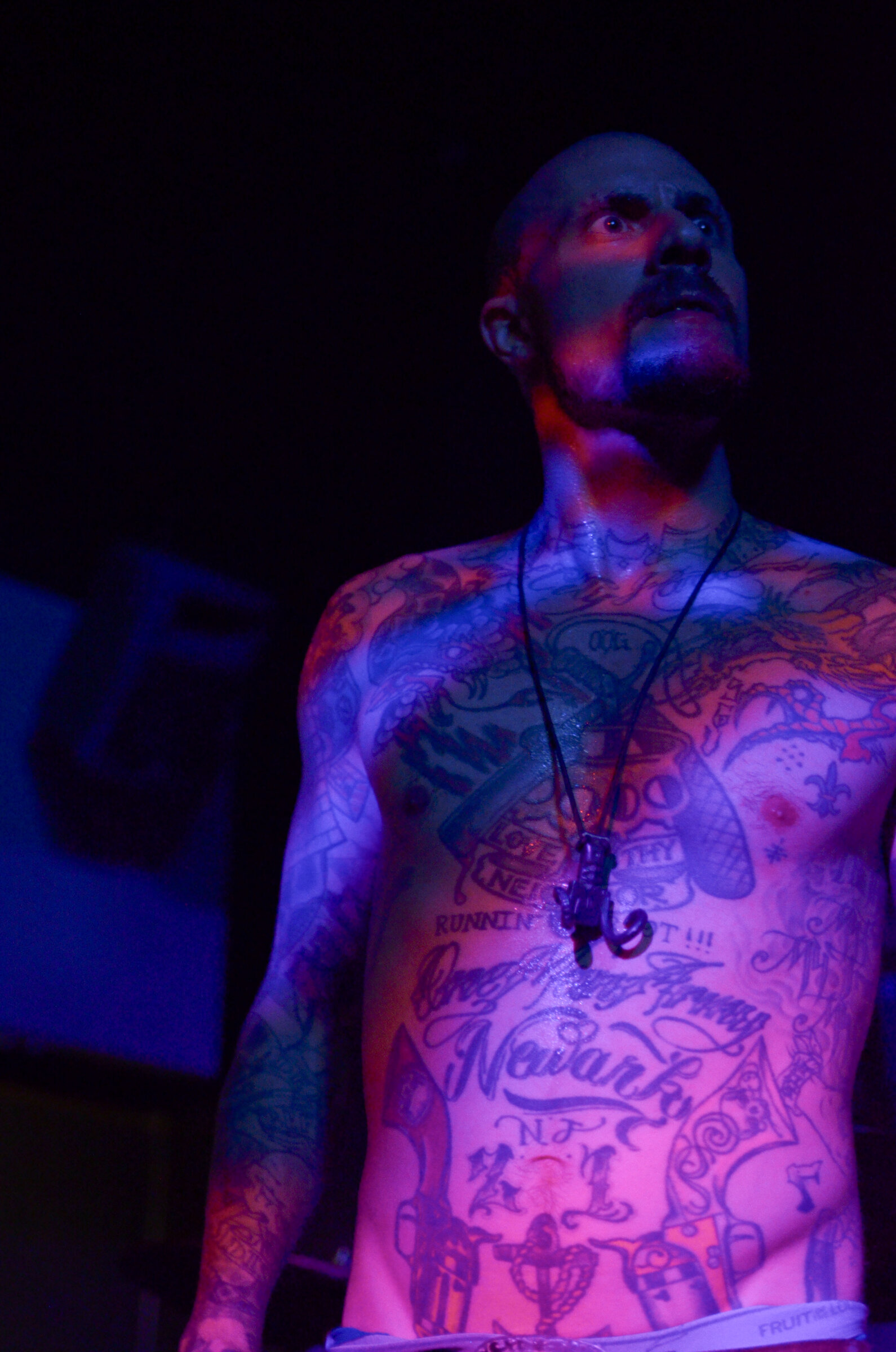 Tattooed torso under ultraviolet light